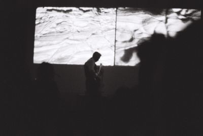 Dark image of Kahu on guitar